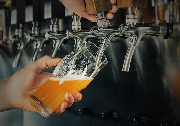 Hands pouring a pint of beer