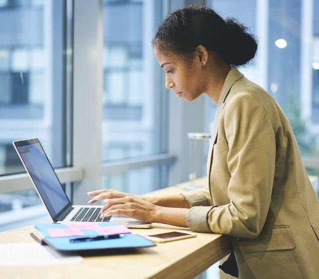 A woman working in front of her laptop