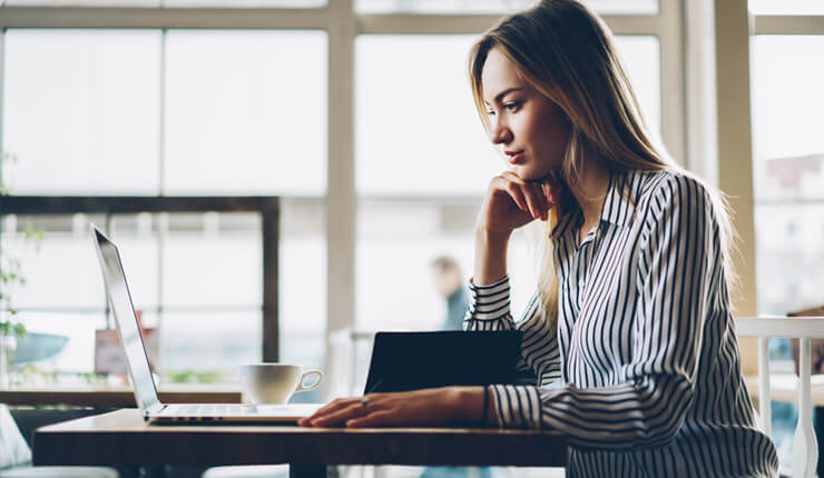 A woman looking at her laptop