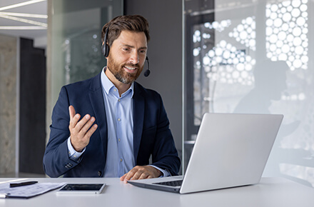 Man in suit talking on laptop