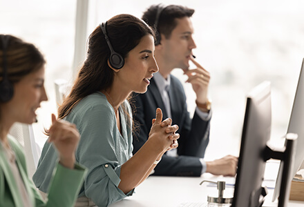 Contact Center Agent in row at desk