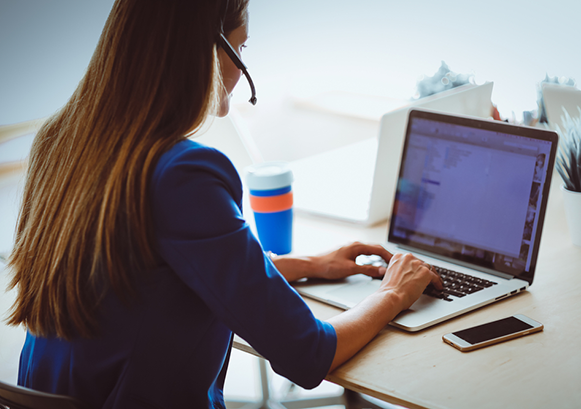 Woman typing on her laptop