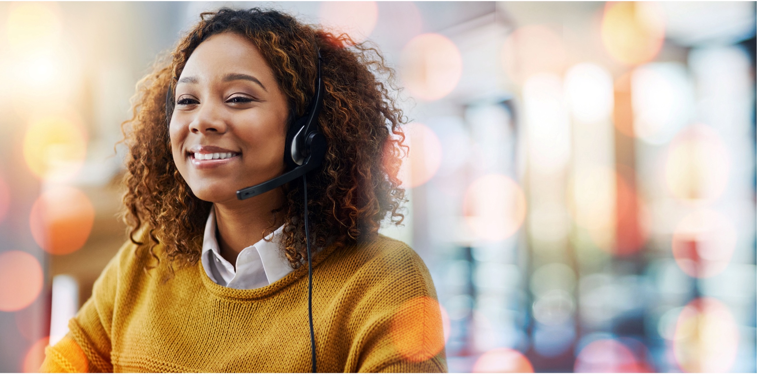 Woman working at a contact center smiling 