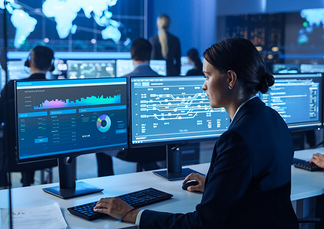 woman at computer screen showing data