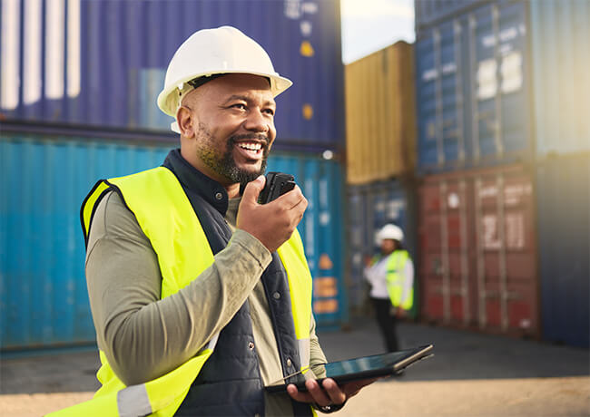 Dock worker on phone in yard