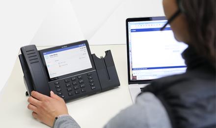 A woman in front of a business phone system